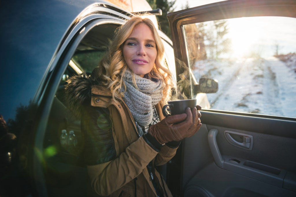 Woman getting out of the car for a cup of coffee.