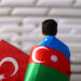 BAKU, AZERBAIJAN - JUNE 20: A Turkey fan wearing a Azerbaijan flag looks on outside the stadium prior to the UEFA Euro 2020 Championship Group A match between Switzerland and Turkey at Baku Olimpiya Stadionu on June 20, 2021 in Baku, Azerbaijan. (Photo by Francois Nel - UEFA/UEFA via Getty Images)