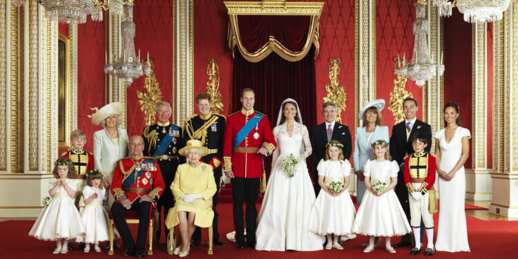 The Royal Wedding Group in the Throne Room at Buckingham Palace on 29th April 2011 with the Bride and Groom, TRH The Duke and Duchess of Cambridge in the centre.
Front row (left to right): Miss Grace van Cutsem, Miss Eliza Lopes, HRH The Duke of Edinburgh, HM The Queen, The Hon. Margarita Armstrong-Jones, Lady Louise Windsor, Master William Lowther-Pinkerton.
Back Row (left to right): Master Tom Pettifer, HRH The Duchess of Cornwall, HRH The Prince of Wales, HRH Prince Henry of Wales, Mr Michael Middleton, Mrs Michael Middleton, Mr James Middleton, Miss Philippa Middleton.
Picture Credit: Photograph by Hugo Burnand