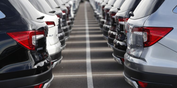 In this Wednesday, Nov. 28, 2018, photograph, a long lines of unsold 2019 Pilot sports-utility vehicles sit at a Honda dealership in Highlands Ranch, Colo. Emotions run high when you’re buying a new or used car. So it’s easy to overlook details that could cost you in the long run. (AP Photo/David Zalubowski)